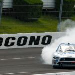 Chase Briscoe (98) celebrates after winning the Pocono Green 225 Recycled Xfinity at Pocono Raceway.