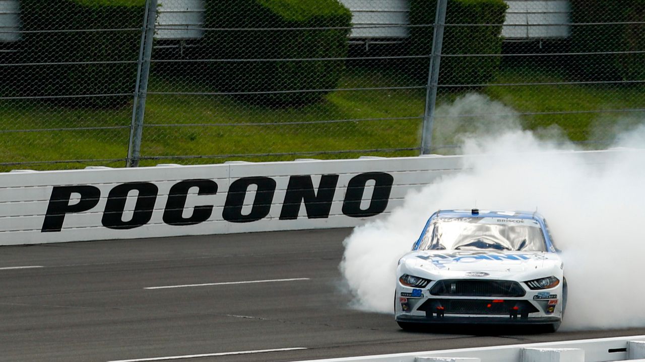 Chase Briscoe (98) celebrates after winning the Pocono Green 225 Recycled Xfinity at Pocono Raceway.