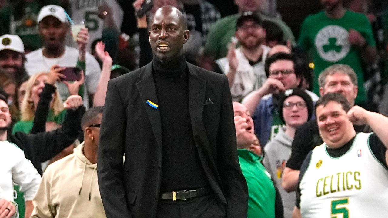 Former Boston Celtic Kevin Garnett reacts to Boston Celtics shooting guard Jaylen Brown (7) dunk (not pictured) during the first half against the Dallas Mavericks at TD Garden.