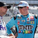 Kyle Busch (right) talks with driver Denny Hamlin (left) on pit road during qualifying for the DuraMAX Drydene 400 at Dover Motor Speedway.