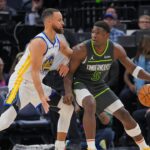 Golden State Warriors guard Stephen Curry (30) defends Minnesota Timberwolves guard Anthony Edwards (5) in the third quarter at Target Center.