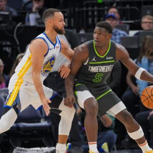 Golden State Warriors guard Stephen Curry (30) defends Minnesota Timberwolves guard Anthony Edwards (5) in the third quarter at Target Center.