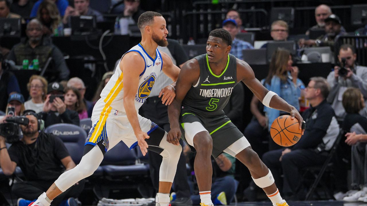 Golden State Warriors guard Stephen Curry (30) defends Minnesota Timberwolves guard Anthony Edwards (5) in the third quarter at Target Center.