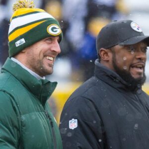 Green Bay Packers quarterback Aaron Rodgers and Pittsburgh Steelers head coach Mike Tomlin talk during warmups prior to the game at Lambeau Field.