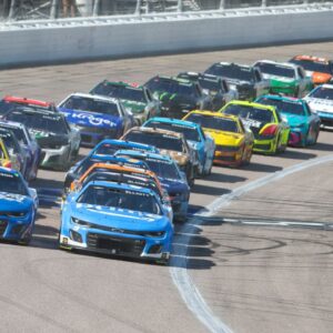 NASCAR Cup Series drivers Chase Elliott (9) and Kyle Larson (5) lead the pack during a restart at the AdventHealth 400 at Kansas Speedway.