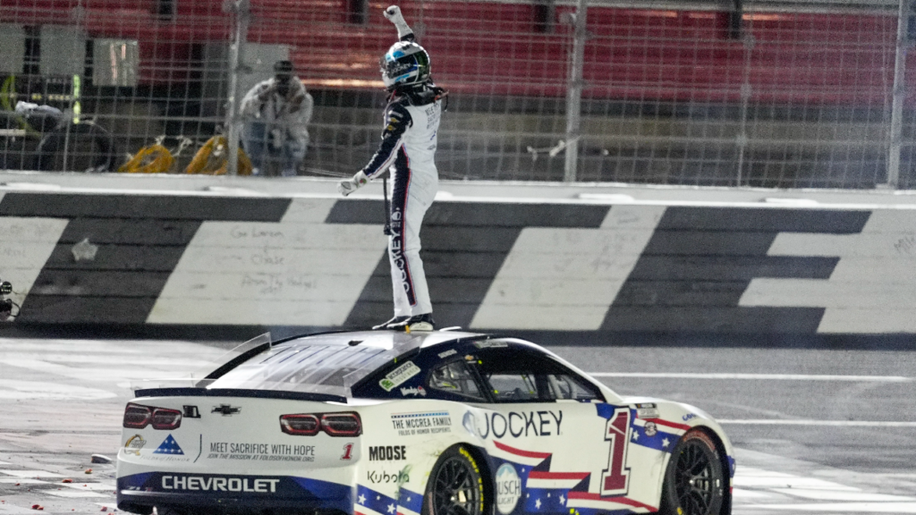 NASCAR Cup Series driver Ross Chastain (1) celebrates his come from behind win with a burnout and tossing a watermelon on the finish line during the Coca Cola 600 at Charlotte Motor Speedway.