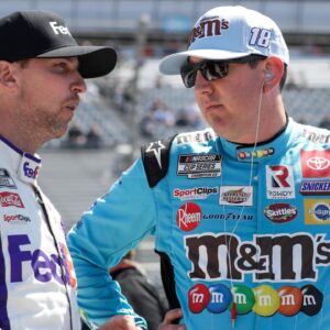 NASCAR Cup Series driver Kyle Busch (right) talks with driver Denny Hamlin (left) on pit road during qualifying for the DuraMAX Drydene 400 at Dover Motor Speedway.