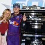 NASCAR Sprint Cup Series driver Denny Hamlin (11) poses with the Harley J. Earl Trophy with his girls Jordan Fish and his daughter Taylor James Hamlin after winning the Daytona 500 at Daytona International Speedway.