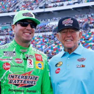 NASCAR Cup Series driver Kyle Busch (left center) and Joe Gibbs Racing owner Joe Gibbs (right center) in pit road prior to the start of the Coke Zero 400 at Daytona International Speedway.