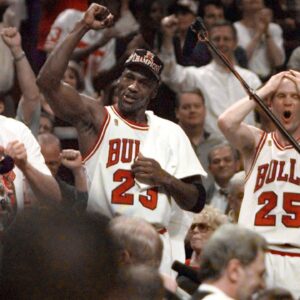 Chicago Bulls players Judd Buechler, left, Michael Jordan, middle, and Steve Kerr celebrate after winning the NBA championship after defeating the Utah Jazz in the 1997 NBA Finals at the United Center.