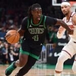 Boston Celtics guard Jrue Holiday (4) controls the ball while New York Knicks guard Josh Hart (3) defends in the second half during game five of the second round for the 2025 NBA Playoffs at TD Garden.