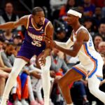 Phoenix Suns forward Kevin Durant (35) handles the ball against Oklahoma City Thunder guard Shai Gilgeous-Alexander (2) during the second quarter at Footprint Center