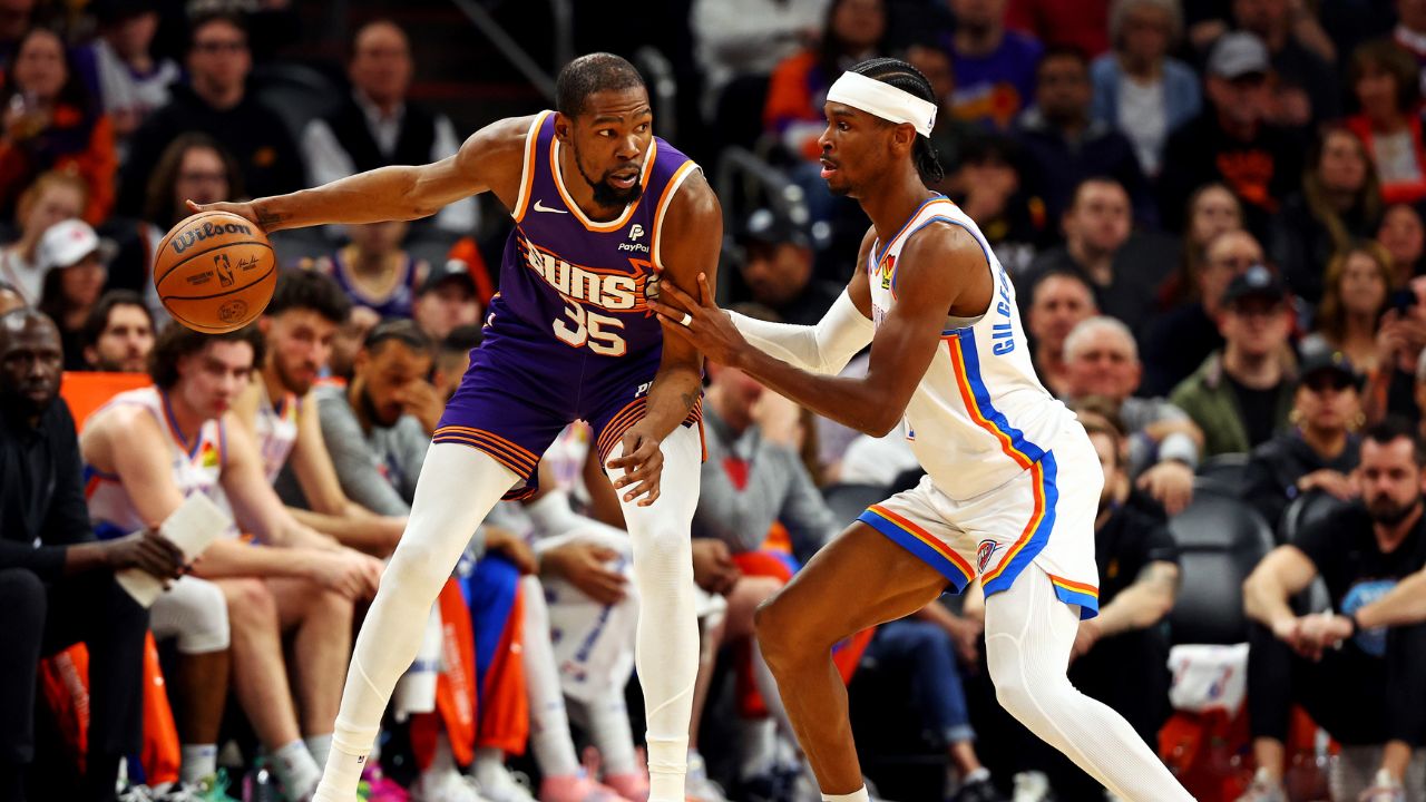 Phoenix Suns forward Kevin Durant (35) handles the ball against Oklahoma City Thunder guard Shai Gilgeous-Alexander (2) during the second quarter at Footprint Center