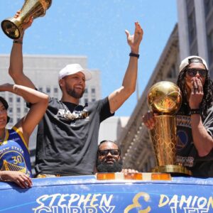 Golden State Warriors guard Stephen Curry (middle left) gestures while standing with wife Ayesha (far left) and guard Damion Lee (middle right) and his wife Sydel Curry (far right) during the Golden State Warriors championship parade in downtown San Francisco