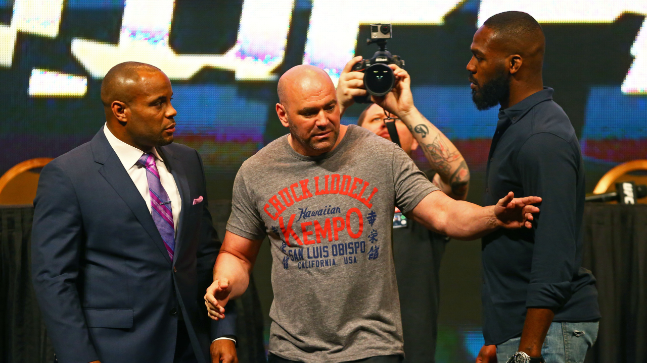 UFC president Dana White (center) separates fighter Jon Jones (right) from Daniel Cormier during a press conference prior to weigh-ins for UFC 196 at MGM Grand Garden Arena.