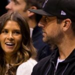 Danica Patrick and Aaron Rodgers look on nduring the first quarter of game three of the first round of the 2018 NBA Playoffs between the Boston Celtics and Milwaukee Bucks at BMO Harris Bradley Center.
