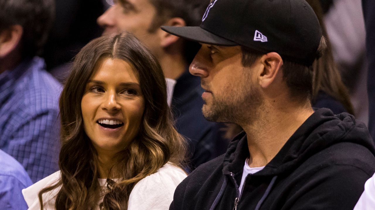 Danica Patrick and Aaron Rodgers look on nduring the first quarter of game three of the first round of the 2018 NBA Playoffs between the Boston Celtics and Milwaukee Bucks at BMO Harris Bradley Center.