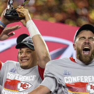 Kansas City Chiefs quarterback Patrick Mahomes (15) raises the Lamar Hunt Trophy with tight end Travis Kelce (87) after the AFC championship NFL game between the Cincinnati Bengals and the Kansas City Chiefs on Jan. 29, 2023, at Arrowhead Stadium in Kansas City.