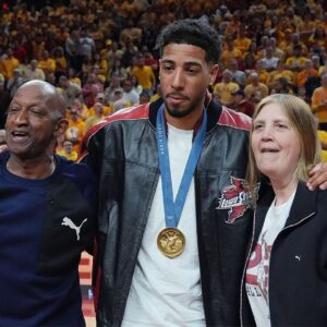 Former Iowa State and Indiana Packer guard Tyrese Haliburton holds his parents John and Brenda Haliburton as the unveiling his Olympic 24 gold made banner during the halftime of Cyclones and Wildcats men’s basketball showdown at Hilton Coliseum on Saturday March 1, 2025 in Ames, Iowa.