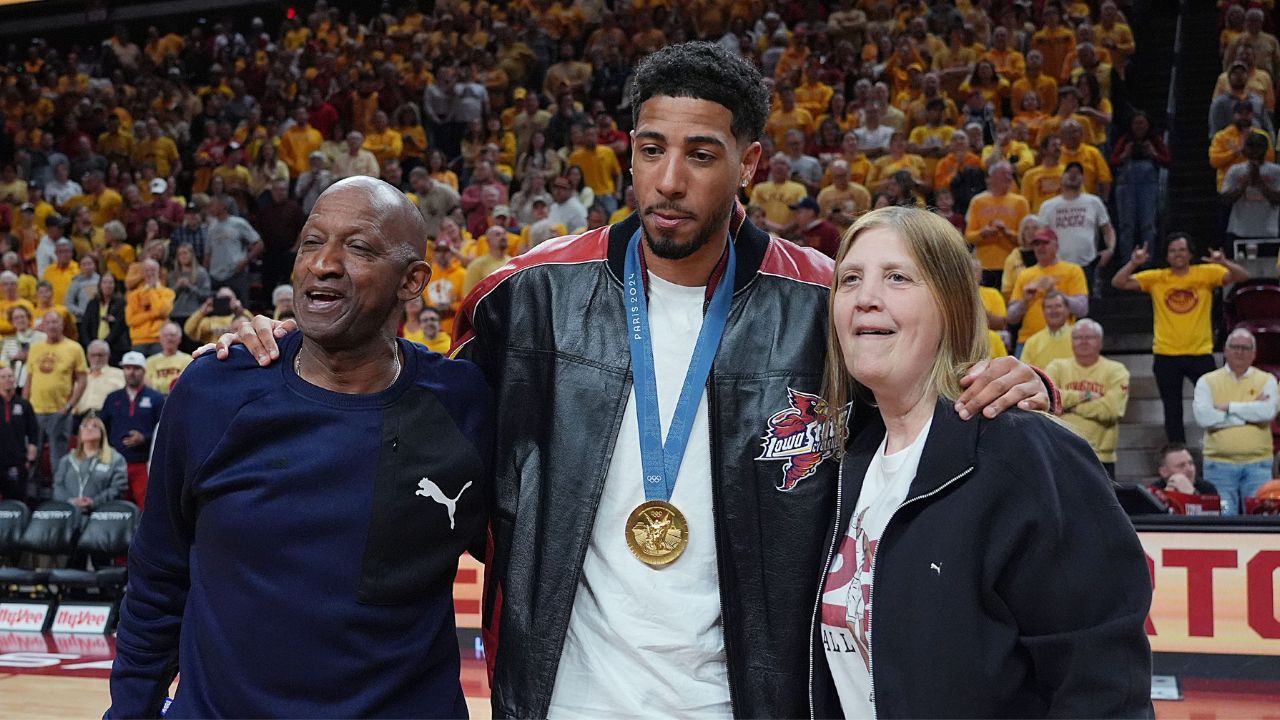 Former Iowa State and Indiana Packer guard Tyrese Haliburton holds his parents John and Brenda Haliburton as the unveiling his Olympic 24 gold made banner during the halftime of Cyclones and Wildcats men’s basketball showdown at Hilton Coliseum on Saturday March 1, 2025 in Ames, Iowa.