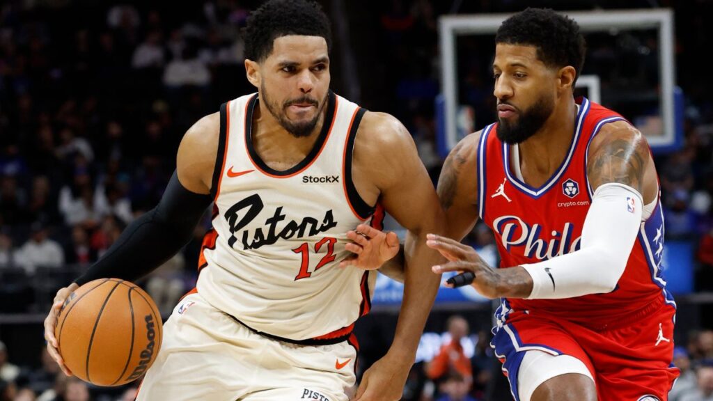 Detroit Pistons forward Tobias Harris (12) dribbles defended by Philadelphia 76ers forward Paul George (8) in the second half at Little Caesars Arena.