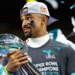 Feb 9, 2025; New Orleans, LA, USA; Philadelphia Eagles quarterback Jalen Hurts (left) and head coach Nick Sirianni celebrate with the Vince Lombardi Trophy after defeating the Kansas City Chiefs during Super Bowl LIX at Ceasars Superdome.