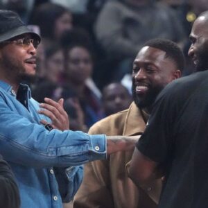 Carmelo Anthony, Dwyane Wade and LeBron James greet each other before the 2023 NBA All-Star Game at Vivint Arena