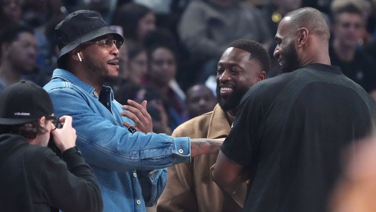 Carmelo Anthony, Dwyane Wade and LeBron James greet each other before the 2023 NBA All-Star Game at Vivint Arena