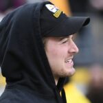 Pittsburgh Steelers quarterback Kenny Pickett (8) watches from the sidelines before a game against the Cincinnati Bengals at Acrisure Stadium.