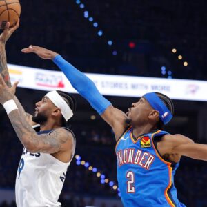 May 22, 2025; Oklahoma City, Oklahoma, USA; Minnesota Timberwolves guard Nickeil Alexander-Walker (9) shoots against Oklahoma City Thunder guard Shai Gilgeous-Alexander (2) in the third quarter during game two of the western conference finals for the 2025 NBA Playoffs at Paycom Center