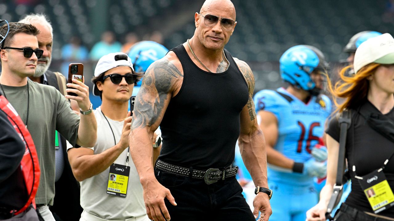 UFL owner Dwayne Johnson aka The Rock walks off the field before the game between the Arlington Renegades and the Birmingham Stallions at Choctaw Stadium.