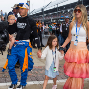 May 26, 2024; Indianapolis, Indiana, USA; Indycar Series driver Kyle Larson holds son Cooper Larson as he walks with daughter Audrey Larson, wife Katelyn Larson and son Owen Larson prior to the 108th running of the Indianapolis 500 at Indianapolis Motor Speedway. Mandatory Credit: Mark J. Rebilas-Imagn Images
