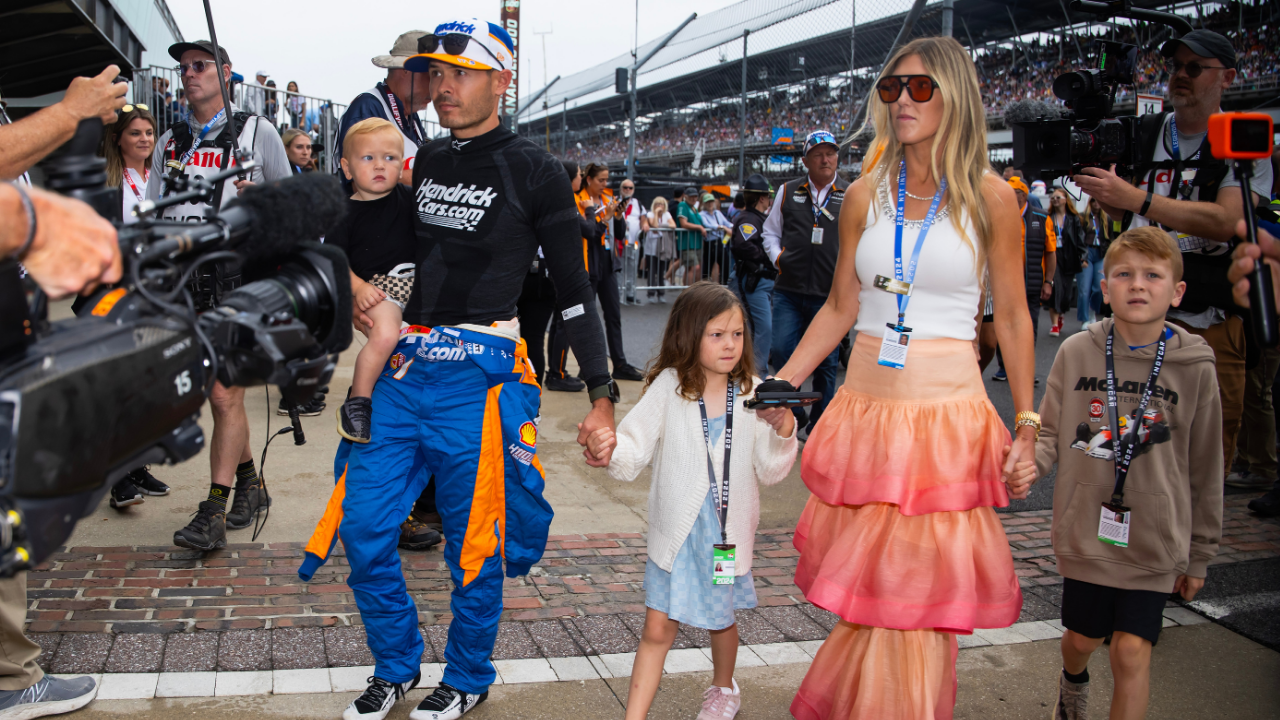 May 26, 2024; Indianapolis, Indiana, USA; Indycar Series driver Kyle Larson holds son Cooper Larson as he walks with daughter Audrey Larson, wife Katelyn Larson and son Owen Larson prior to the 108th running of the Indianapolis 500 at Indianapolis Motor Speedway. Mandatory Credit: Mark J. Rebilas-Imagn Images