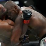 Jon Jones and Daniel Cormier hold onto one another during UFC 214 at Honda Center.