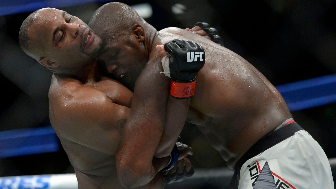 Jon Jones and Daniel Cormier hold onto one another during UFC 214 at Honda Center.
