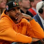 New York Knicks former player Carmelo Anthony sits courtside during the second half between the Villanova Wildcats and the Georgetown Hoyas at Madison Square Garden.