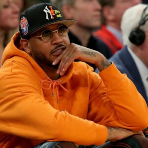 New York Knicks former player Carmelo Anthony sits courtside during the second half between the Villanova Wildcats and the Georgetown Hoyas at Madison Square Garden.