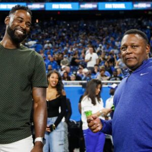Detroit Lions legend Calvin Johnson talks to Barry Sanders before kickoff against Seattle Seahawks at Ford Field in Detroit on Sunday, Sept. 17, 2023.