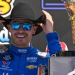 NASCAR Xfinity Series driver Kyle Larson (88) tries on a cowboy hat in Victory Lane after he wins the NASCAR Xfinity race at Texas Motor Speedway.