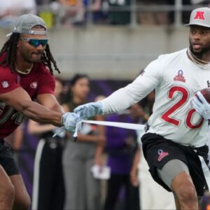 AFC running back Joe Mixon of the Houston Texans (28) carries the ball against NFC linebacker Fred Warner of the San Francisco 49ers (54) during the 2025 Pro Bowl Games flag football game at Camping World Stadium.