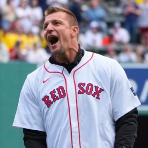 Former NFL player Rob Gronkowski reacts to throwing out a ceremonial first pitch prior to the game between the Cleveland Guardians and Boston Red Sox at Fenway Park.