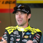 Ryan Blaney talks with crewmen, Wednesday February 12, 2025 as they wait for the start of the first cup practice at Daytona International Speedway as teams gear up for the Daytona 500.