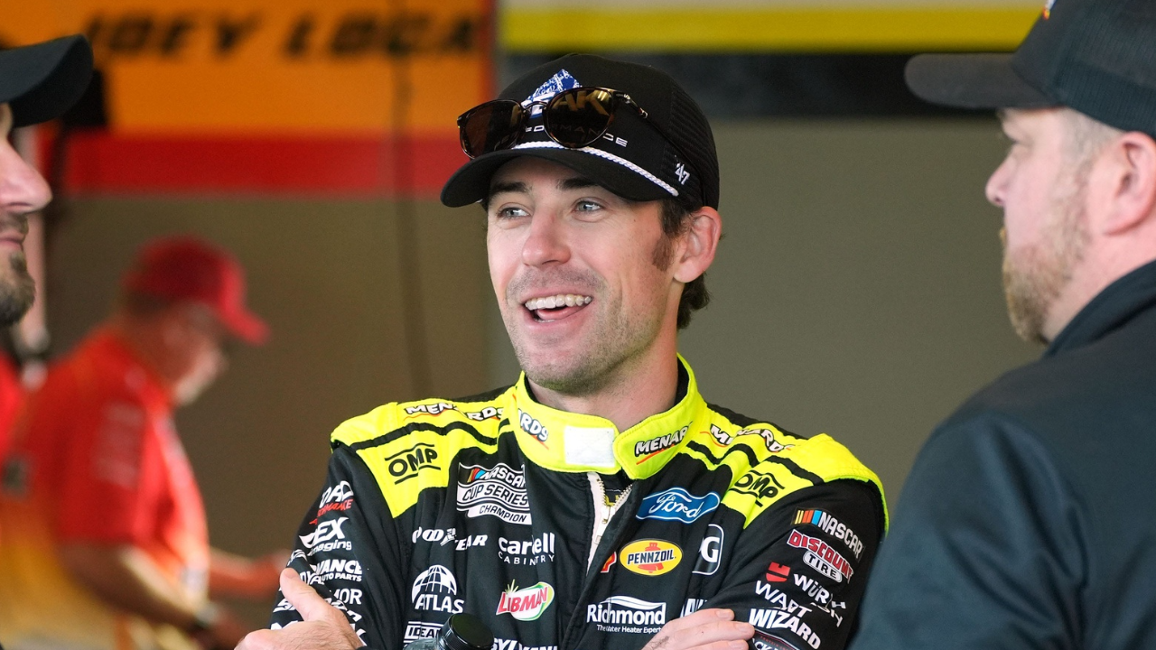 Ryan Blaney talks with crewmen, Wednesday February 12, 2025 as they wait for the start of the first cup practice at Daytona International Speedway as teams gear up for the Daytona 500.