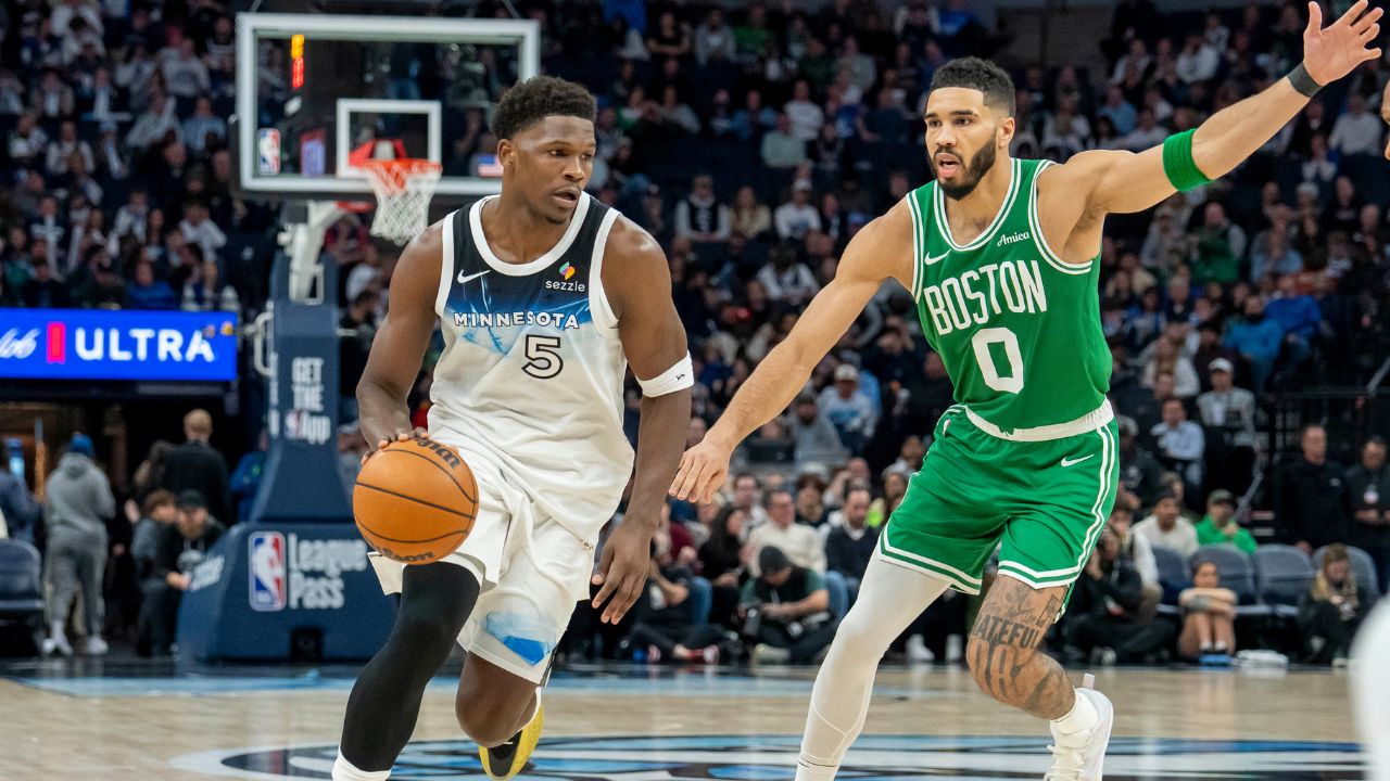 Minnesota Timberwolves guard Anthony Edwards (5) dribbles past Boston Celtics forward Jayson Tatum (0) in the second half at Target Center