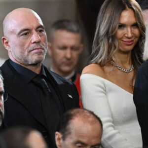 US media personality Joe Rogan stands for a benediction after President Donald Trump was sworn in as the 47th US President in the US Capitol Rotunda in Washington