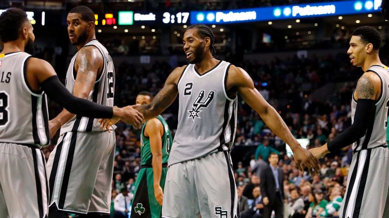 Nov 25, 2016; Boston, MA, USA; San Antonio Spurs forward Kawhi Leonard (2) is congratulated after a basket by guard Patty Mills (8) and guard Danny Green (14) during the second half of the San Antonio Spurs 109-103 win over the Boston Celtics at TD Garden. Mandatory Credit: Winslow Townson-Imagn Images