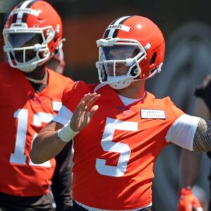 Cleveland Browns quarterback Dillon Gabriel (5) throws as quarterback Shedeur Sanders (12) looks on during NFL rookie minicamp at the Cleveland Browns training facility on Friday, May 9, 2025, in Berea, Ohio.