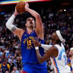 May 9, 2025; Denver, Colorado, USA; Oklahoma City Thunder guard Shai Gilgeous-Alexander (2) defends Denver Nuggets center Nikola Jokic (15) in the second half during game three of the second round for the 2025 NBA Playoffs at Ball Arena. Mandatory Credit: Ron Chenoy-Imagn Images