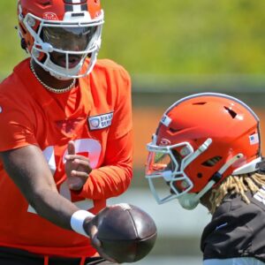 Cleveland Browns quarterback Shedeur Sanders (12) hands the ball off to Cleveland Browns running back Quinshon Judkins (10) during day two of NFL rookie minicamp at the Cleveland Browns training facility on Saturday, May 10, 2025, in Berea, Ohio.