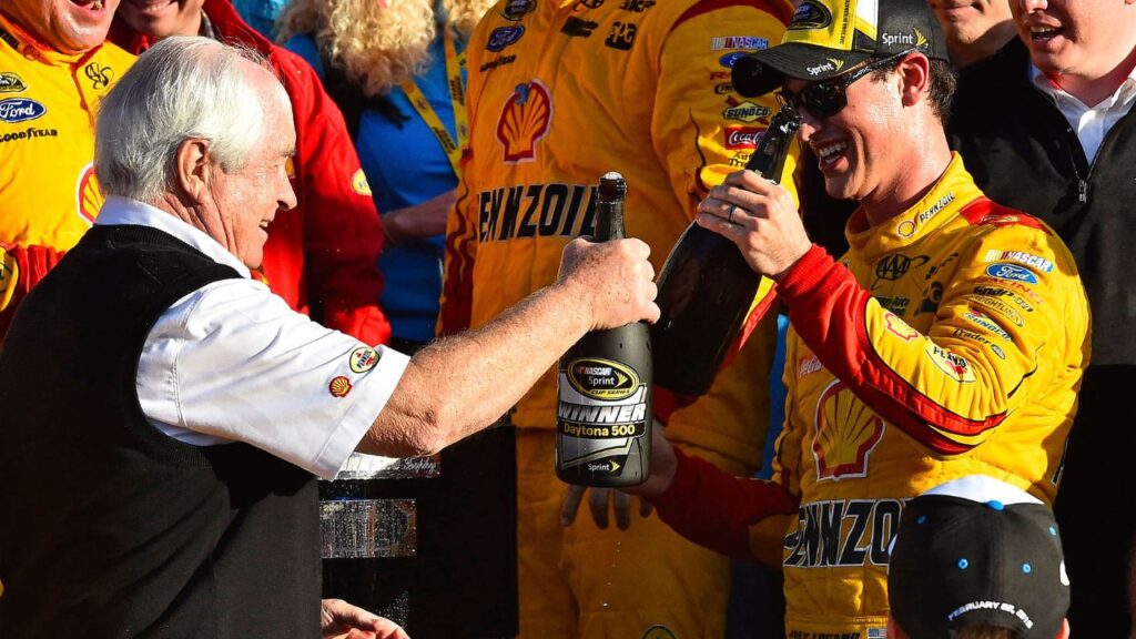 NASCAR Sprint Cup Series driver Joey Logano (22) celebrates with team owner Roger Penske in victory lane after winning the Daytona 500 at Daytona International Speedway.